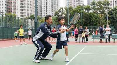 Coach teaching junior backhand at Victoria Park