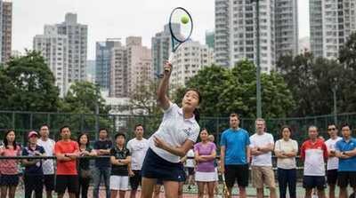 Junior girl serving at Victoria Park